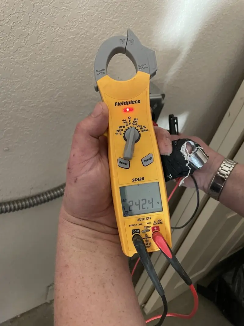 Voltage testing with clamp meter during Electrical Installation Services in Starkey